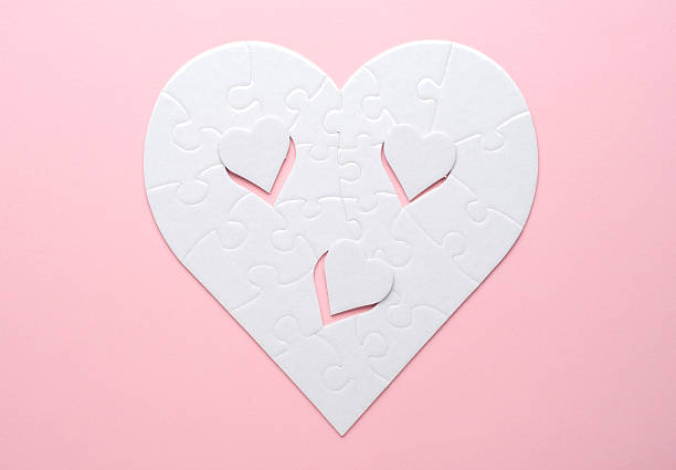 istock White heart-shaped jigsaw puzzle on a grey background, with several pieces missing and placed nearby. Symbolizing love, connection, or incompleteness, perfect for themes of relationships and emotions. 2207765450