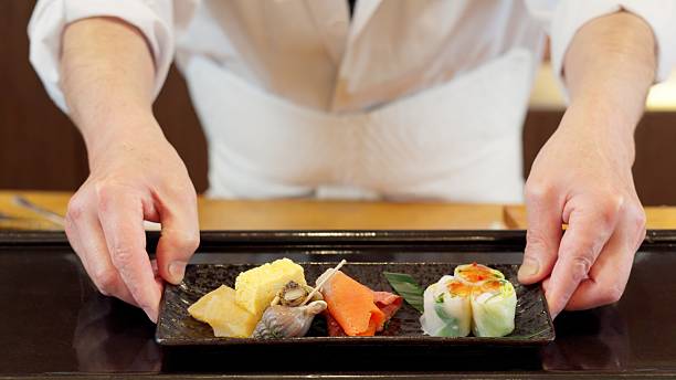 istock Chef's hands offering Japanese food 2207765459