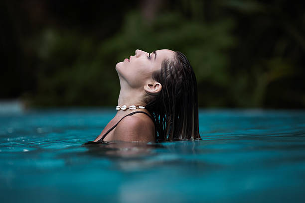 istock Young beautiful woman in swimming pool. 2207765782