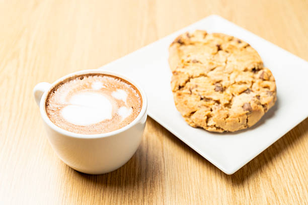 istock Chocolate chip cookies with cappuccino on wooden table 2207765860