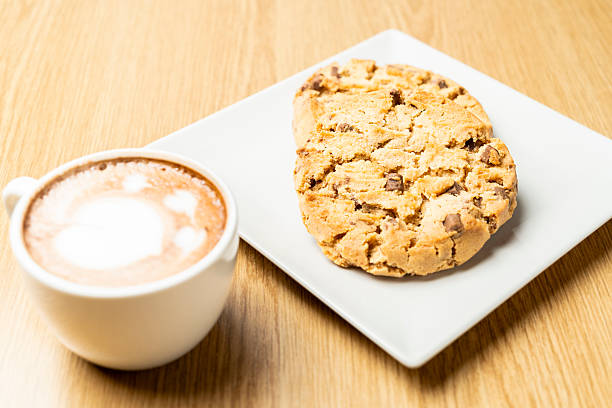 istock Chocolate chip cookies with cappuccino on wooden table 2207765864