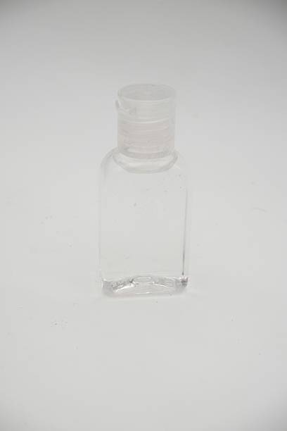 istock An empty clear glass bottle with a screw cap, presented on a pristine white background 2207765994