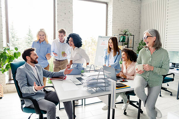istock Group of diverse coworkers brainstorming ideas in a modern office with large windows, multi-age 2207766257