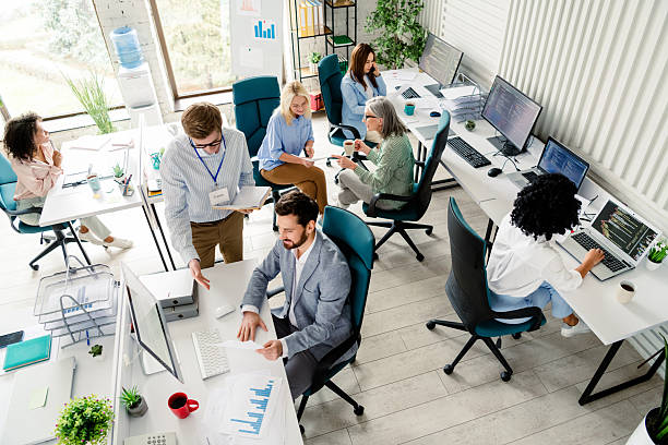 istock Group of business professionals collaborating in a modern open office workspace 2207766275