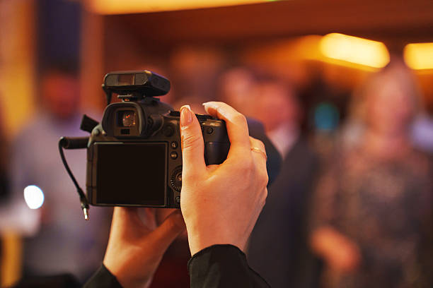 istock Capturing moments with a camera at a festive indoor gathering 2207766781