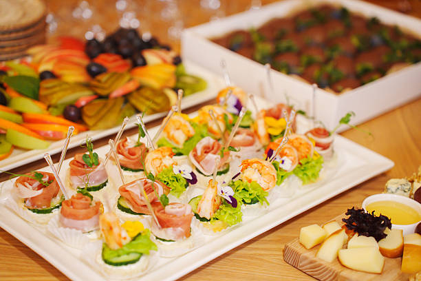 istock Elegant catering display featuring sushi, fruit, and desserts at an event 2207766869