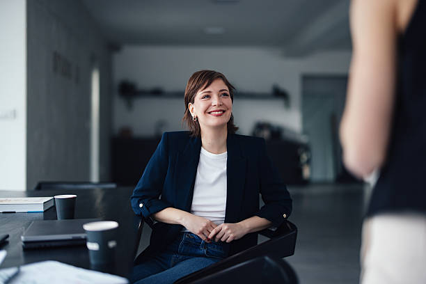 istock Businesswoman Smiling During an Engaging Office Discussion in Modern Workspace 2207770873