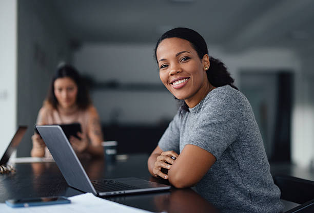 istock Professional Woman Smiling in a Co-Working Office Environment 2207770896