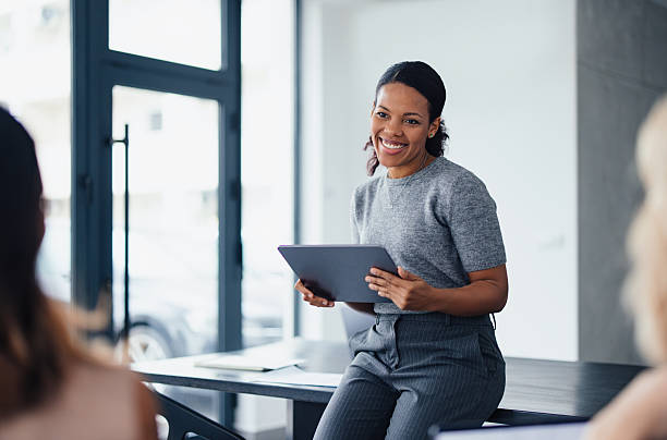 istock Professional Woman Smiling During Business Presentation in a Modern Office 2207770906
