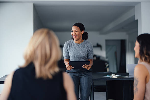 istock Confident Female Leader Facilitating Collaborative Business Meeting in Modern Office Environment 2207770908