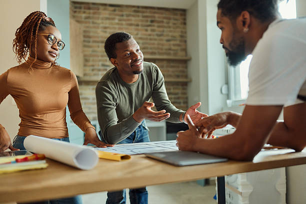 istock Happy African American couple talking about plans with their manual worker. 2207770974