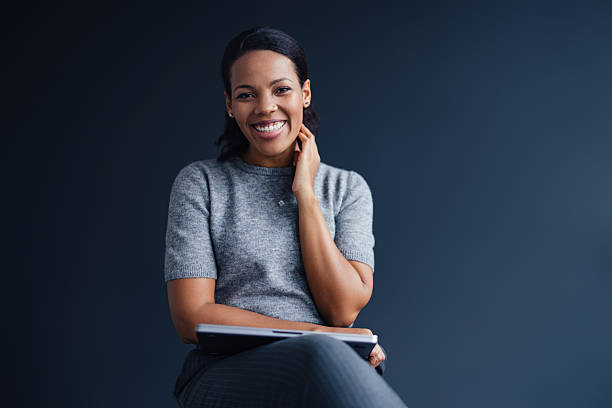 istock Confident Professional Woman Smiling While Holding Notebook in a Modern Office 2207770984