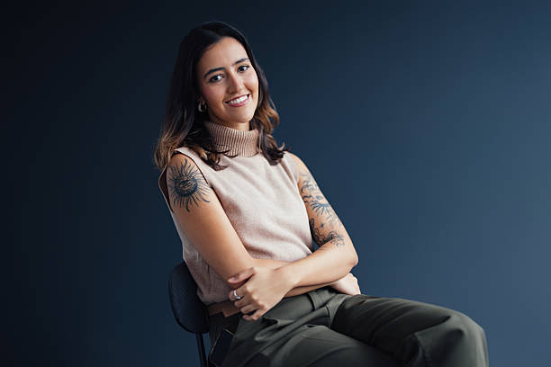 istock Confident Woman Sitting in a Modern Minimalist Studio Setting 2207770985