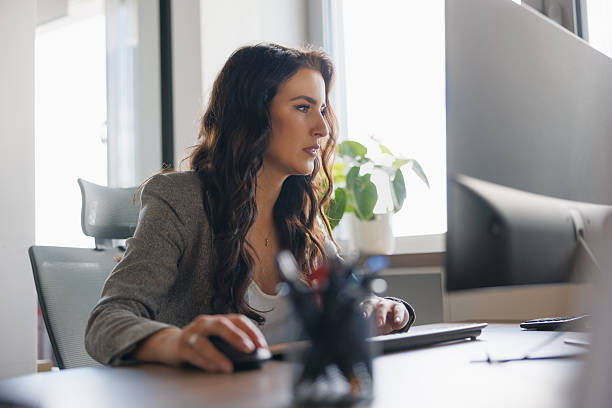 istock Beautiful businesswoman using computer at the office desk 2207771554