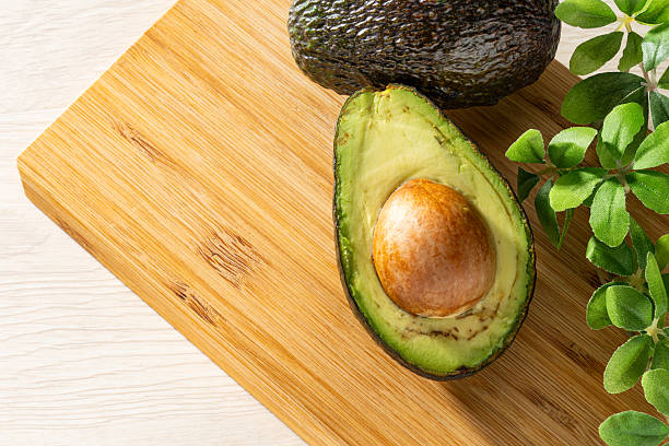 istock Fresh organic avocado on wooden table 2207771866