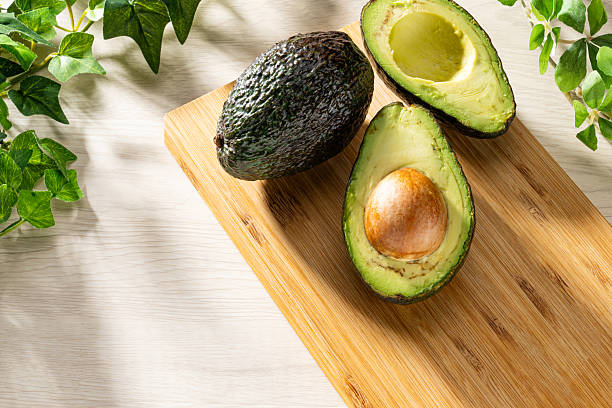 istock Fresh organic avocado on wooden table 2207771874