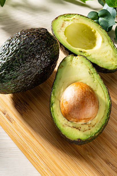 istock Fresh organic avocado on wooden table 2207771877