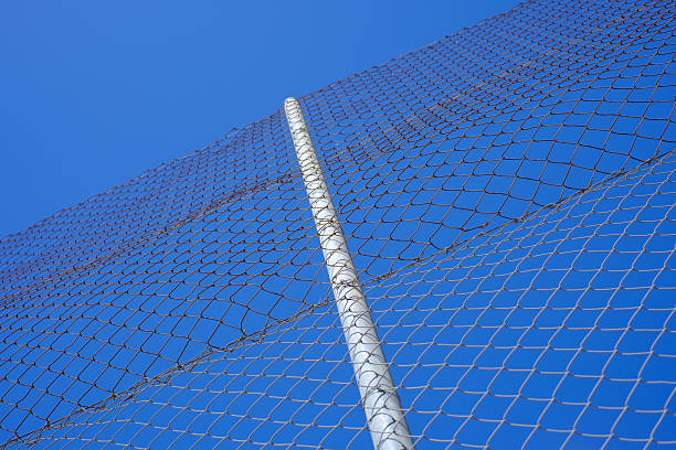 istock Chain link fence against clear blue sky: modern security and boundary concept 2207773142