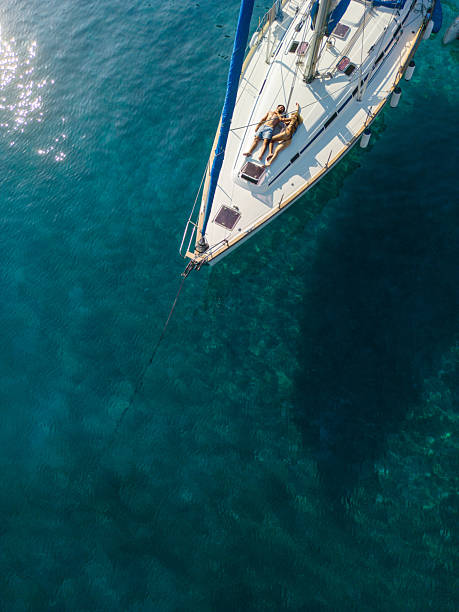 istock Young couple enjoying vacation on sailboat 2207773211