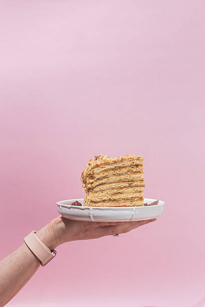 istock Piece of cake in a plate on a pink background 2207775575
