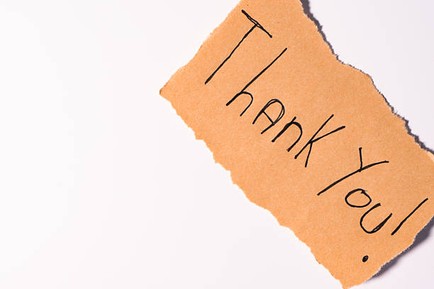 istock A Thank you note on brown paper, on a white background 2207776452