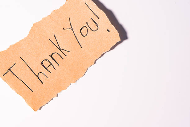 istock A Thank you note on brown paper, on a white background 2207776510