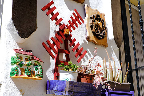 istock Colorful wall art with decorative windmill and ceramic house in bright sunlight 2207777489