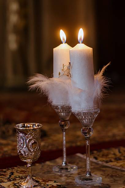 Candles and ornate silver cup on a decorative rug create a warm, inviting ambiance