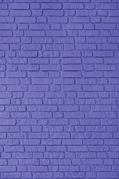 istock Purple color painted brick wall texture, brickwork, masonry of stone blocks vertical background 2207782531