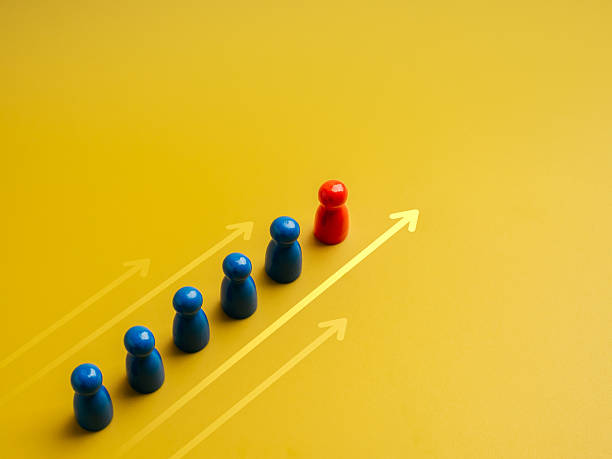 istock The red different one, leader, leading white peg dolls group, team symbol, with moving forward arrow on yellow background. Leadership, manager, unique, influencer, talent people, teamwork concept. 2207785237