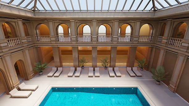 istock Luxurious indoor pool area showcases elegant classical architecture with arched windows and palm trees, creating a serene atmosphere for relaxation and leisure. 3d render 2207789903