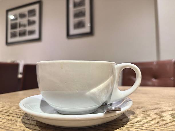istock A coffee cup and a saucer on a table in a coffee shop 2207790161
