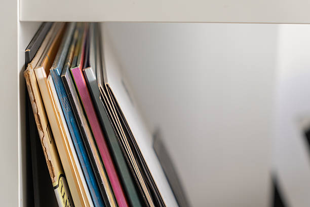 istock Colorful vinyl record sleeves in a white shelf closeup 2207791006