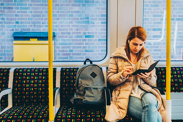 istock Commuter engrossed in an e-book while riding public transport. 2207794630
