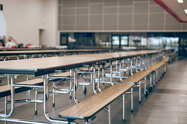 istock Blurry parents and students at cafeteria lunchroom middle school, empty row of rectangle mobile tables, bench seats modern laminate top resists scratches and stains, powder-coated steel frame 2207795967