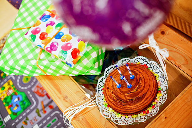 birthday zebra vanilla chocolate cake with chocolate and four blue candles. Gift prepared for child birthday.