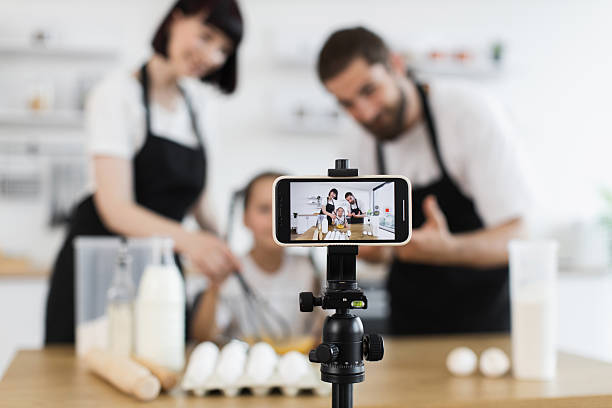 istock Family bloggers recording cooking activity in home kitchen using smartphone 2207797238