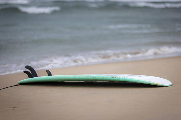 istock Surfboard on sands with seascape. 2207802044