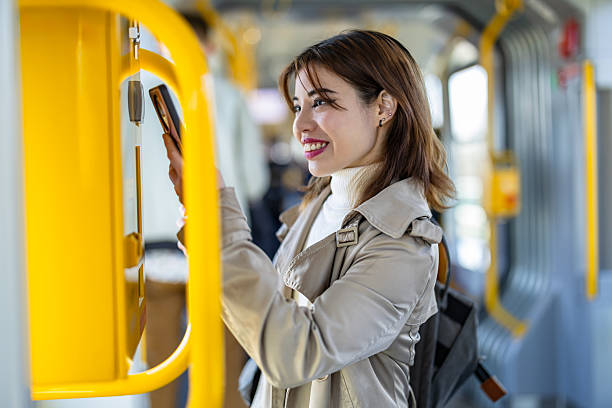 istock Young woman buying a ticket from a machine in a tram 2207802688