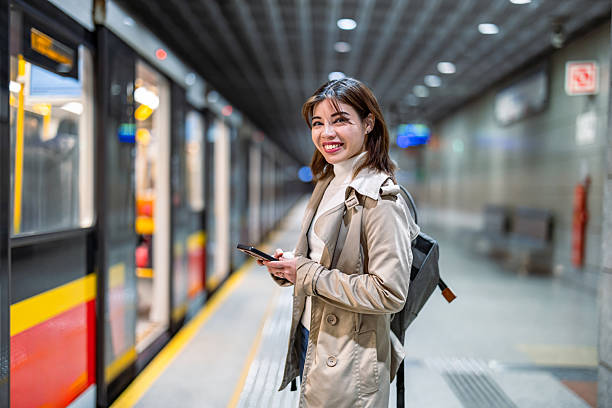 istock Smiling young woman using mobile phone in a public transport 2207802759