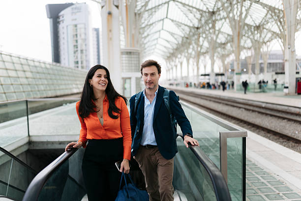 istock Businesspeople going up on escalator in train station 2207803225
