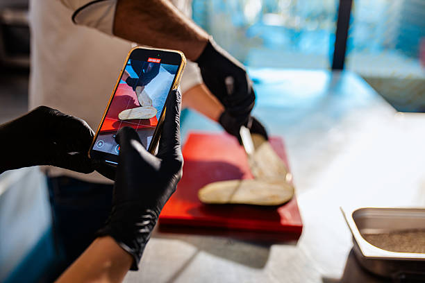 istock Couple enjoying a cooking class with a chef preparing eggplant for a meal in the kitchen. 2207803565