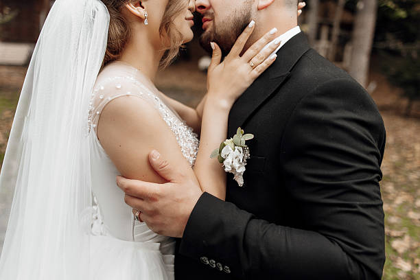 istock A bride and groom are embracing each other in a park 2207806728