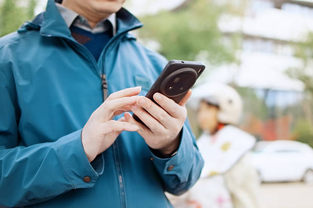 istock asian man using smart phone outside of office building 2207808585