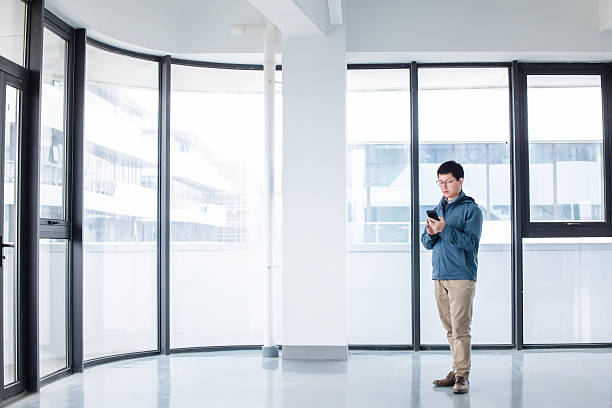 istock asian businessman using smart phone in modern office 2207810182