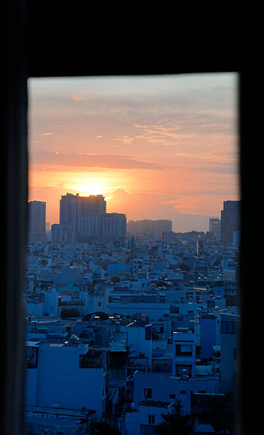 istock Gradient golden sunset with blue shadow on buildings and residents 2207811528