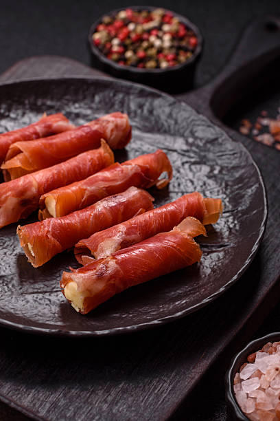 istock Cheese and meat, jamon or prosciutto rolled into a roll 2207813379