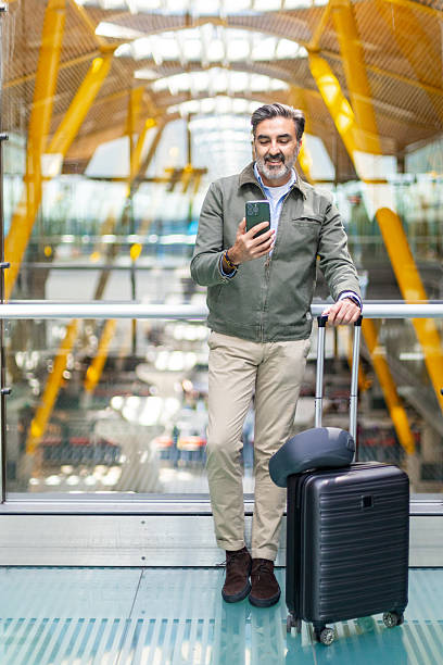 istock Businessman using smartphone while waiting at the airport 2207816459