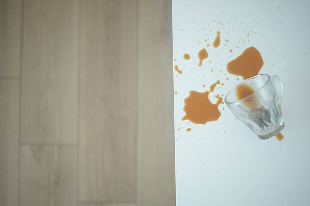 istock A drink was accidentally spilled on a desk with a laptop and glasses, creating a mess 2207818422