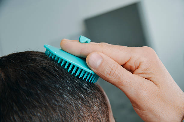 istock man in the bathroom combing his hair 2207819132